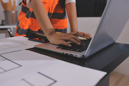 Closeup of team of industrial engineers meeting analyze machinery blueprints consult project on table in manufacturing factory. Working in manufacturing plant or production plant.の写真素材