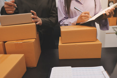Portrait of Starting small businesses SME owners, two Asian woman check online orders Selling...
