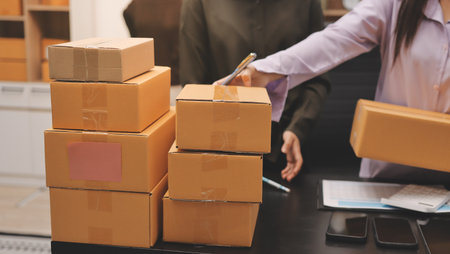 Portrait of Starting small businesses SME owners, two Asian woman check online orders Selling...