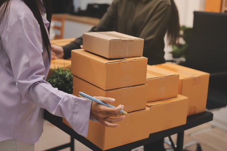 Portrait of Starting small businesses SME owners, two Asian woman check online orders Selling...