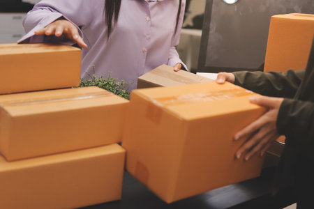 Portrait of Starting small businesses SME owners, two Asian woman check online orders Selling...