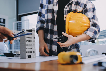 Construction and structure concept of engineer working drawing on blueprint meeting for project...