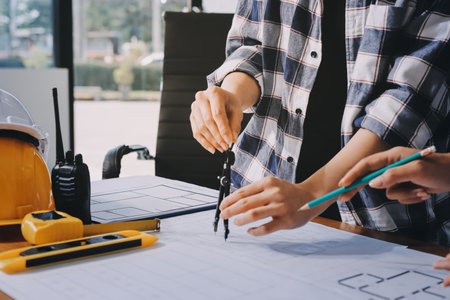 Construction and structure concept of engineer working drawing on blueprint meeting for project...