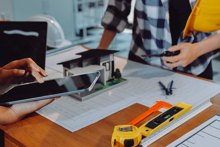 Construction and structure concept of engineer working drawing on blueprint meeting for project...