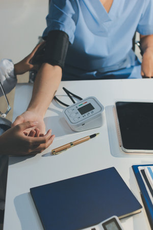Doctor checking patient arterial blood pressure in hospital.