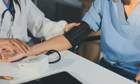 Doctor checking patient arterial blood pressure in hospital. Health care Concept