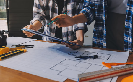 Construction and structure concept of engineer working drawing on blueprint meeting for project...
