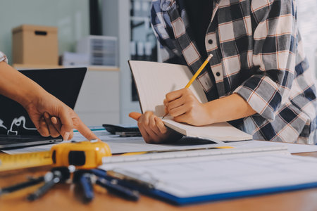 Construction and structure concept of engineer working drawing on blueprint meeting for project...