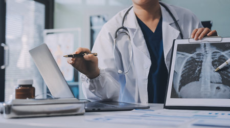Medical team meeting analyzing blood test results in hospital laboratory. Doctors and scientists in...