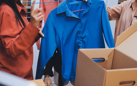 Portrait of Starting small businesses SME owners, two Asian woman check online orders Selling products working with boxs freelance work at home office, sme business online small medium enterpriseの写真素材