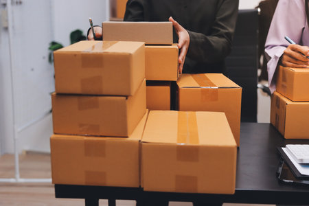 Portrait of Starting small businesses SME owners, two Asian woman check online orders Selling...