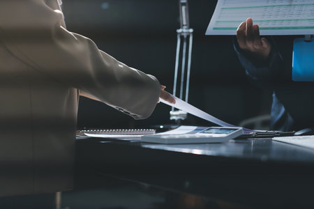 Close up high angle Asian businesswoman working with her coworker in meeting room