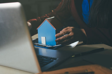 Customer signing a real estate contract in real estate agency.