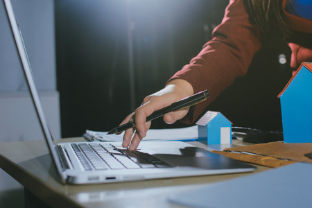 Customer signing a real estate contract in real estate agency.