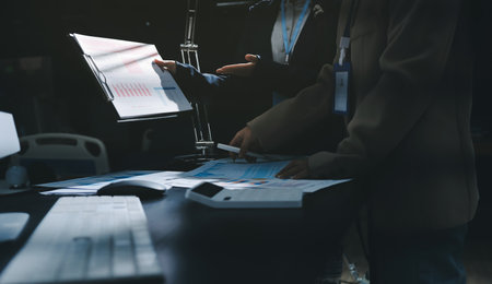 Close up high angle Asian businesswoman working with her coworker in meeting room
