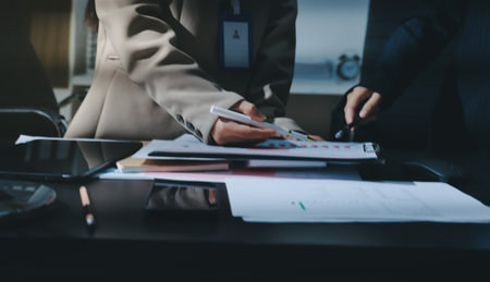 Close up high angle Asian businesswoman working with her coworker in meeting room