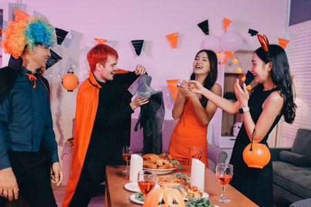 Friends enjoying a Halloween party making a toastの写真素材