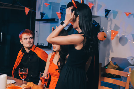 Friends enjoying a Halloween party at a bar making a toastの写真素材
