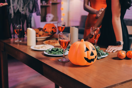 Friends enjoying a Halloween party at a bar making a toastの写真素材