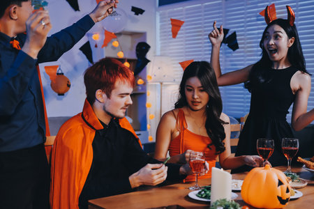 Joyful Halloween party with coworkers in costumes, celebrating with drinks and laughter, fostering...