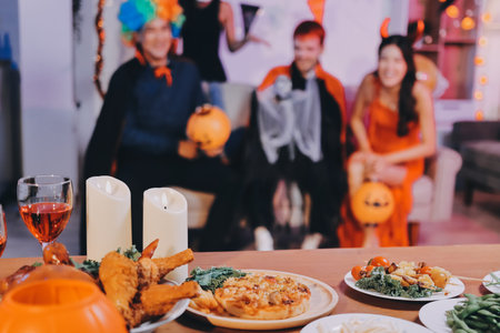 Joyful office Halloween party with coworkers in costumes, celebrating with drinks and laughter, fostering teamwork and festive spiritの写真素材