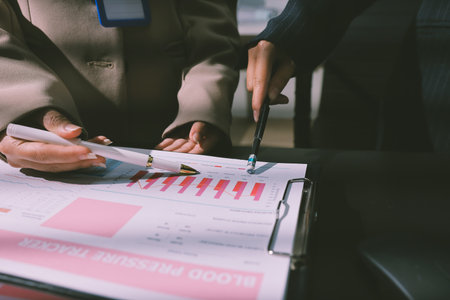 Close up high angle Asian businesswoman working with her coworker in meeting room