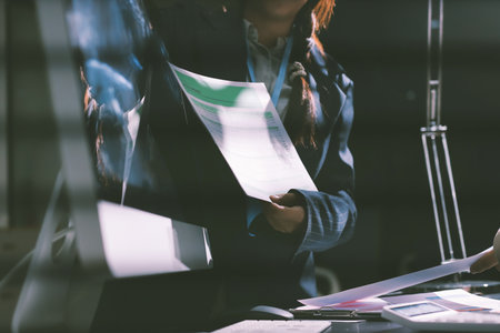 Close up high angle Asian businesswoman working with her coworker in meeting room