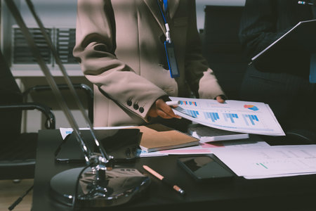 Close up high angle Asian businesswoman working with her coworker in meeting roomの写真素材