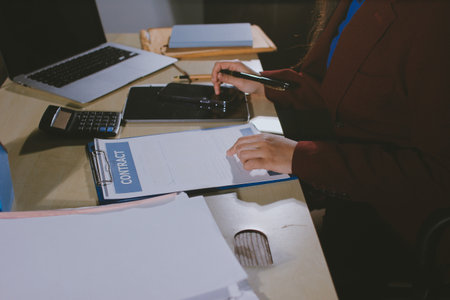 Customer signing a real estate contract in real estate agency.