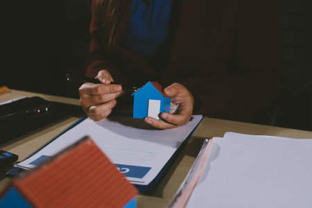 Customer signing a real estate contract in real estate agency.