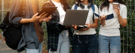 Happy students walking together on university campus, chatting and laughing outdoors after classes
