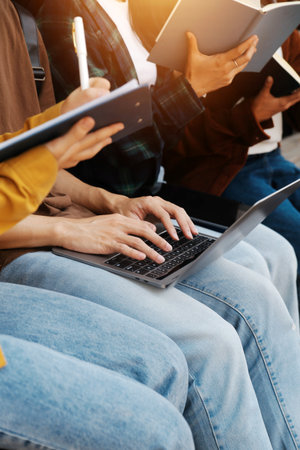 Students walking together on university campus, chatting and laughing outdoors after classesの写真素材