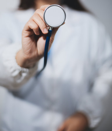 A young male doctor holding an stethoscopeの写真素材