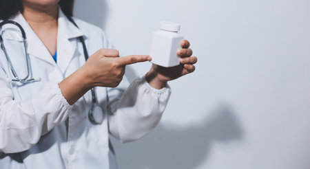 The pharmacist or doctor holding medication or medicine for treatment. Anti biotic pill in the vial.の写真素材