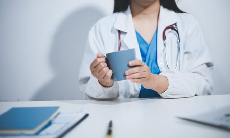 Female scientist holding coffee mug in laboratoryの写真素材