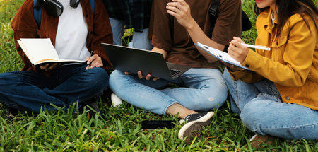Happy students walking together on university campus, chatting and laughing outdoors after classesの写真素材