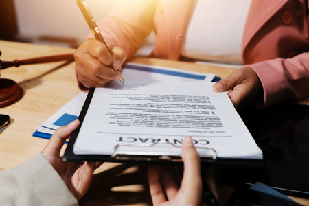 Consultation and conference of professional businesswoman and Male lawyers working and discussion having at law firm in office. Concepts of law, Judge gavel with scales of justiceの写真素材