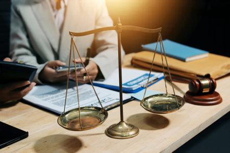 Consultation and conference of professional businesswoman and Male lawyers working and discussion having at law firm in office. Concepts of law, Judge gavel with scales of justiceの写真素材