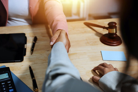 Consultation and conference of professional businesswoman and Male lawyers working and discussion having at law firm in office. Concepts of law, Judge gavel with scales of justiceの写真素材