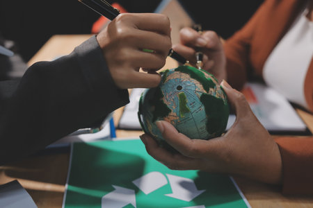 Asian woman lead young group of multiethnic businesspeople in team meeting, using laptop computer for ESG topic presentation on monitor. Sustainable business practice, people work at home conceptの写真素材