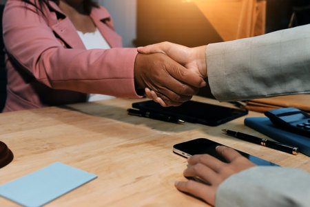 Consultation and conference of professional businesswoman and Male lawyers working and discussion having at law firm in office. Concepts of law, Judge gavel with scales of justiceの写真素材