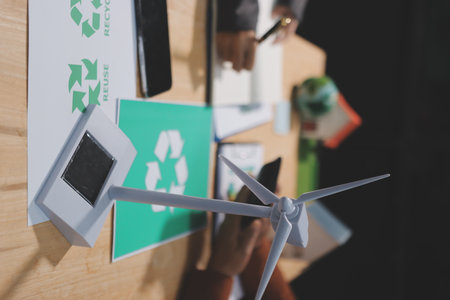 Asian woman lead young group of multiethnic businesspeople in team meeting, using laptop computer for ESG topic presentation on monitor. Sustainable business practice, people work at home conceptの写真素材