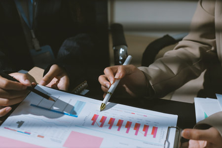 Close up high angle Asian businesswoman working with her coworker in meeting roomの写真素材