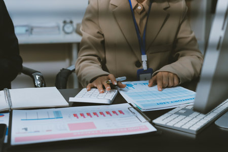Close up high angle Asian businesswoman working with her coworker in meeting room
