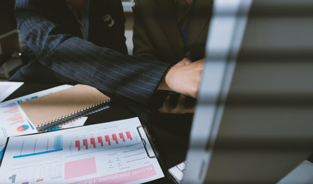 Close up high angle Asian businesswoman working with her coworker in meeting room