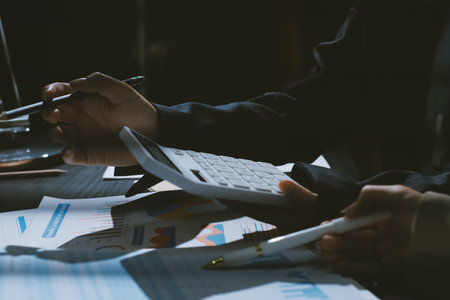Close up high angle Asian businesswoman working with her coworker in meeting roomの写真素材