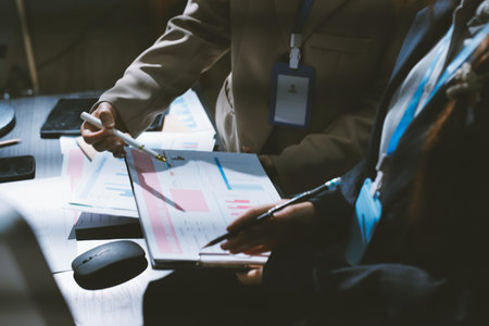 Close up high angle Asian businesswoman working with her coworker in meeting room