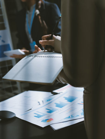 Close up high angle Asian businesswoman working with her coworker in meeting room