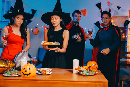 Joyful office Halloween party with coworkers in costumes, celebrating with drinks and laughter, fostering teamwork and festive spiritの写真素材