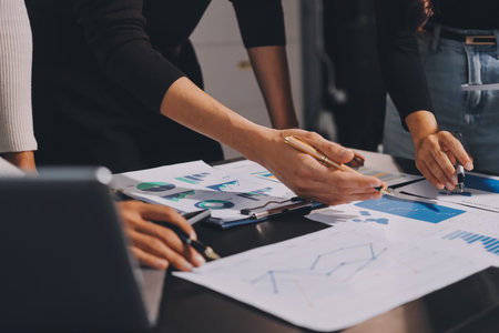 Accounting company provide finance and taxation planning for profitable cash flow, Auditor and accountant team working in office, analyze financial data and accounting record with calculator.Insightの写真素材